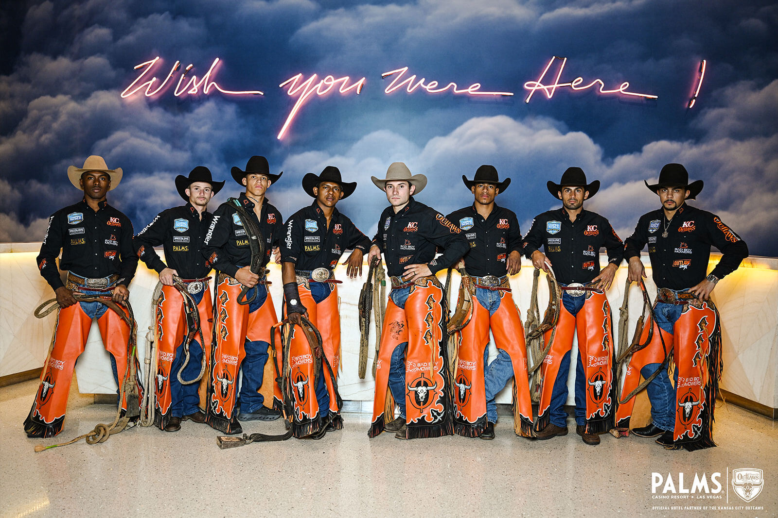 The KC Outlaws standing in front of a Wishing You Were Here sign in Las Vegas!